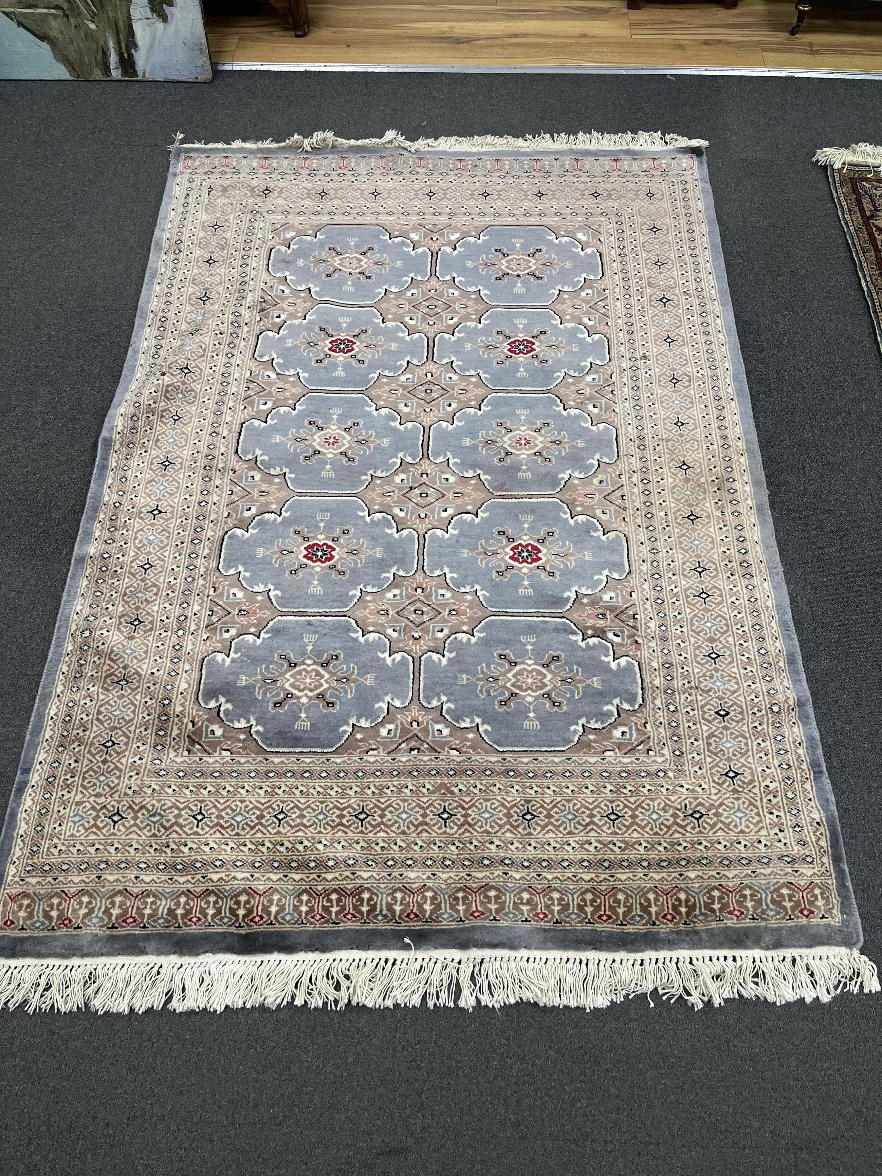 A Bokhara part silk blue ground rug, 80 x 125cm